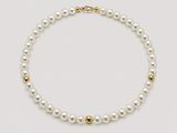 a white pearl necklace with a gold clasp