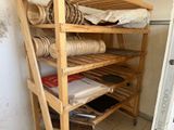 a wooden shelf with several rolls of paper on it