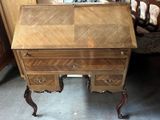 a wooden desk with a mirror on top of it