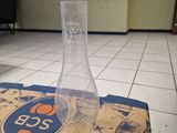 a glass vase sitting on top of a box on the floor