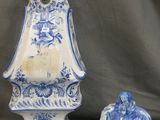 two blue and white vases sitting next to each other