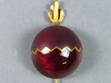 a picture of a red christmas ornament with a gold crown on it