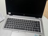 an open laptop computer sitting on top of a table next to a cup of coffee