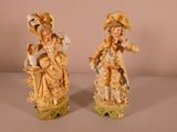 pair of antique figurines of a woman and a child