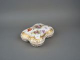 a small white box with a floral design on it