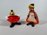 two figurines of a woman and a man sitting next to each other