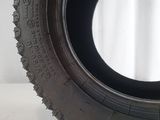 a close up of a tire on a white surface