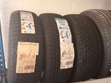 several tires are stacked on a shelf in a garage