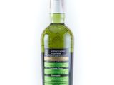 a bottle of green liquor on a white background