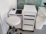 a white desk with a chair and a computer on it