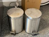 two trash cans sitting next to each other on the floor