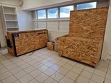 a room that has a refrigerator and some boxes on the floor