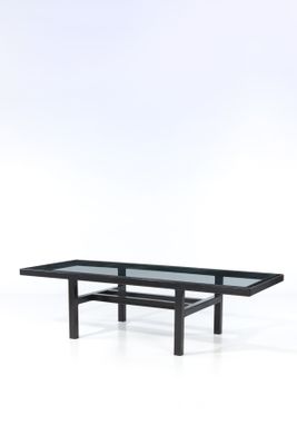 a black coffee table with a glass top on a white background
