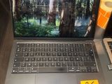 a laptop computer sitting on a table with a price tag