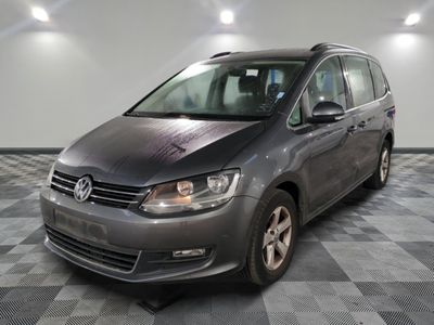 the grey volkswagen touran is parked in a large room