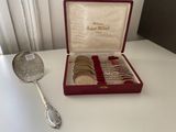 a silver spoon and a set of silver spoons on a table