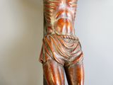 a statue of a man holding a cross on a table