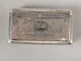 an antique silver cigarette case with a picture of a woman on it
