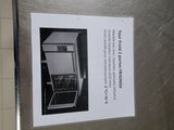 a picture of a stainless steel refrigerator with a sign on it