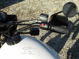 a close up of a motorcycle ' s handlebars and mirror