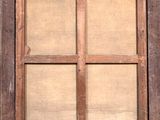 an old window with a wooden frame on the outside
