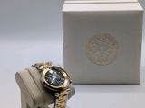 an image of a watch sitting on a stand next to a box