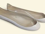 pair of women ' s white ballet shoes on a white surface