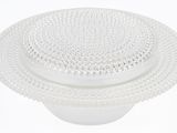 a white plate with a plastic lid on a white table