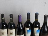 several bottles of wine are lined up on a wooden table