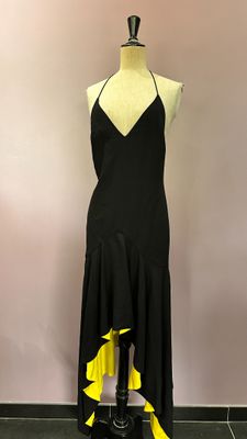 black and yellow asymmetrical dress on a mannequin mannequin