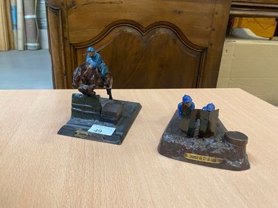 deux figurines représentant un homme à cheval, posées sur une table en bois