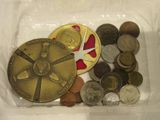 a plastic container filled with coins and a pair of scissors