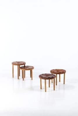 trois tabourets et une table au milieu d'une pièce blanche