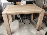 a wooden table with a white chair in the middle of it