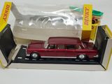 a red toy car in a box with a shark in the background