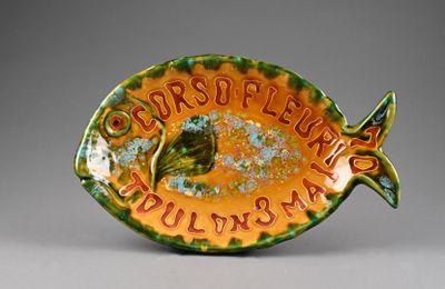 a green and orange plate with a fish on it