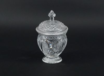 an image of a clear glass jar with a lid on a black background