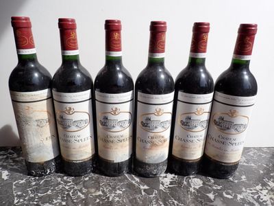 six bottles of wine are lined up in a row on a table