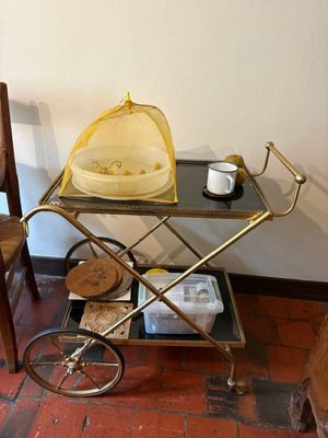 a small cart with a basket on top of it