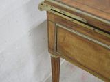 a small wooden table with a drawer on top of it