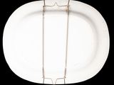 a white plate with a silver necklace on it