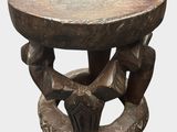 an image of a wooden stool with carvings on it