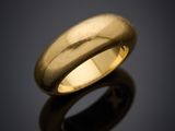 a close up of a gold ring on a black surface