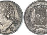 une pièce d'argent surmontée d'une couronne