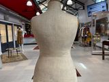 a mannequin on a wooden stand in a room
