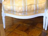 a chair and ottoman in a room with wood flooring