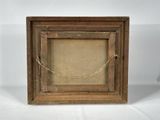 an old picture frame with a rope hanging from it ' s side