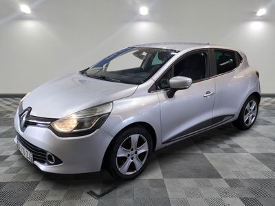 a silver car is parked in a room with a checkered floor