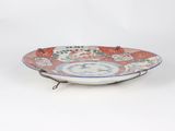 a red and white plate with a clock on it