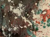 a cake with splats of paint on top of it